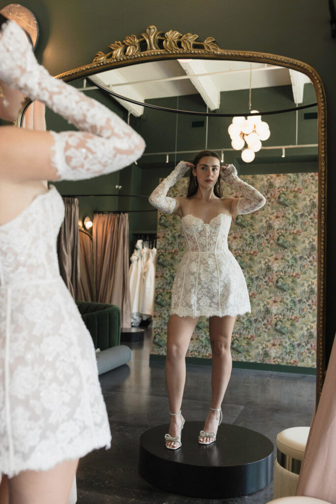 Modern Elopement and Civil Ceremony Bridal Looks: Woman in Cowboy Bride Salon in stunning lace mini dress.
